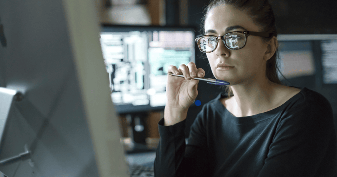 Hacker looking at data on computer screen