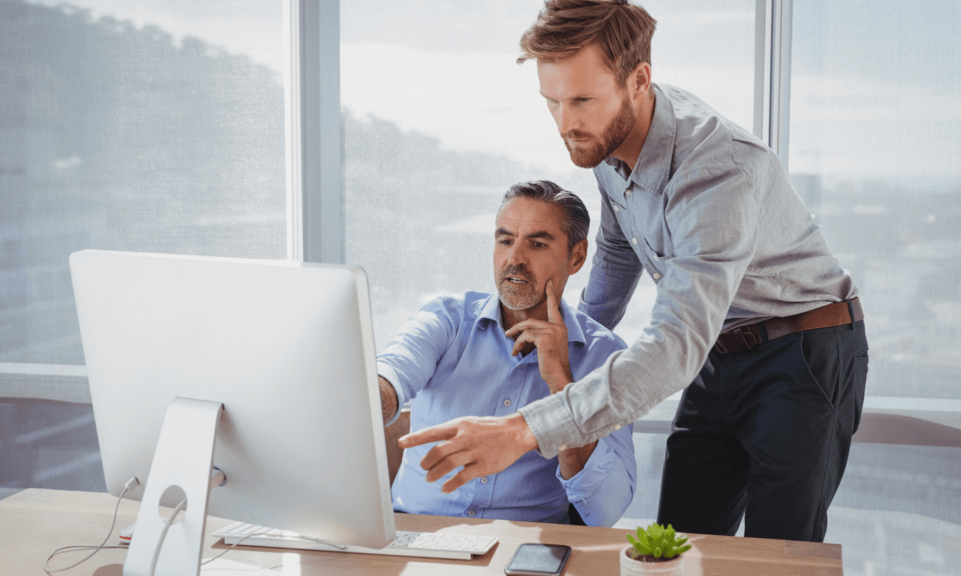 Colleagues looking at secure email solution in office