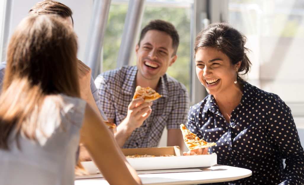 Business team eating pizza together