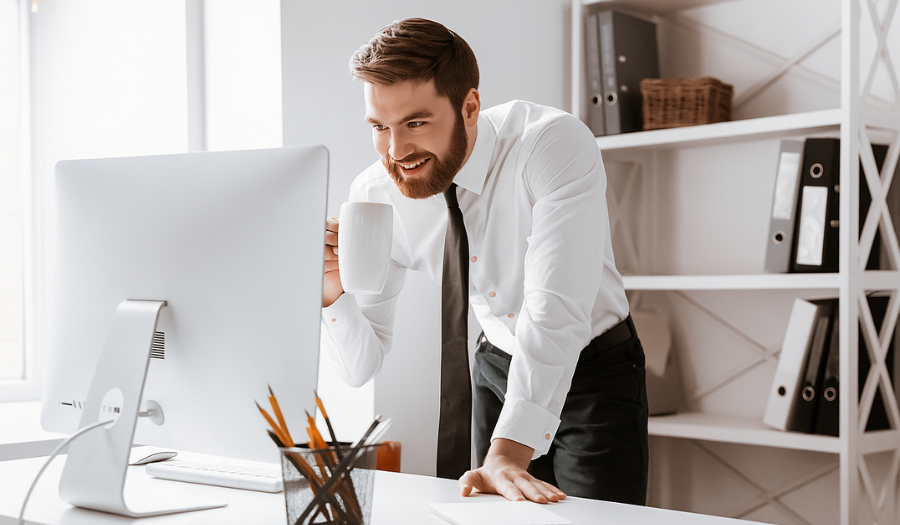 Financial adviser looking at screen in his office