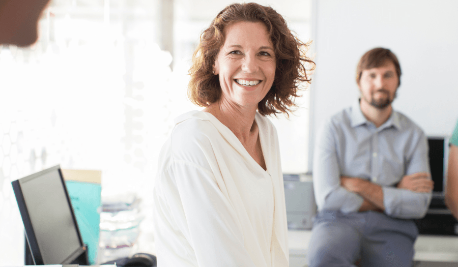 Head of compliance looking and smiling in office