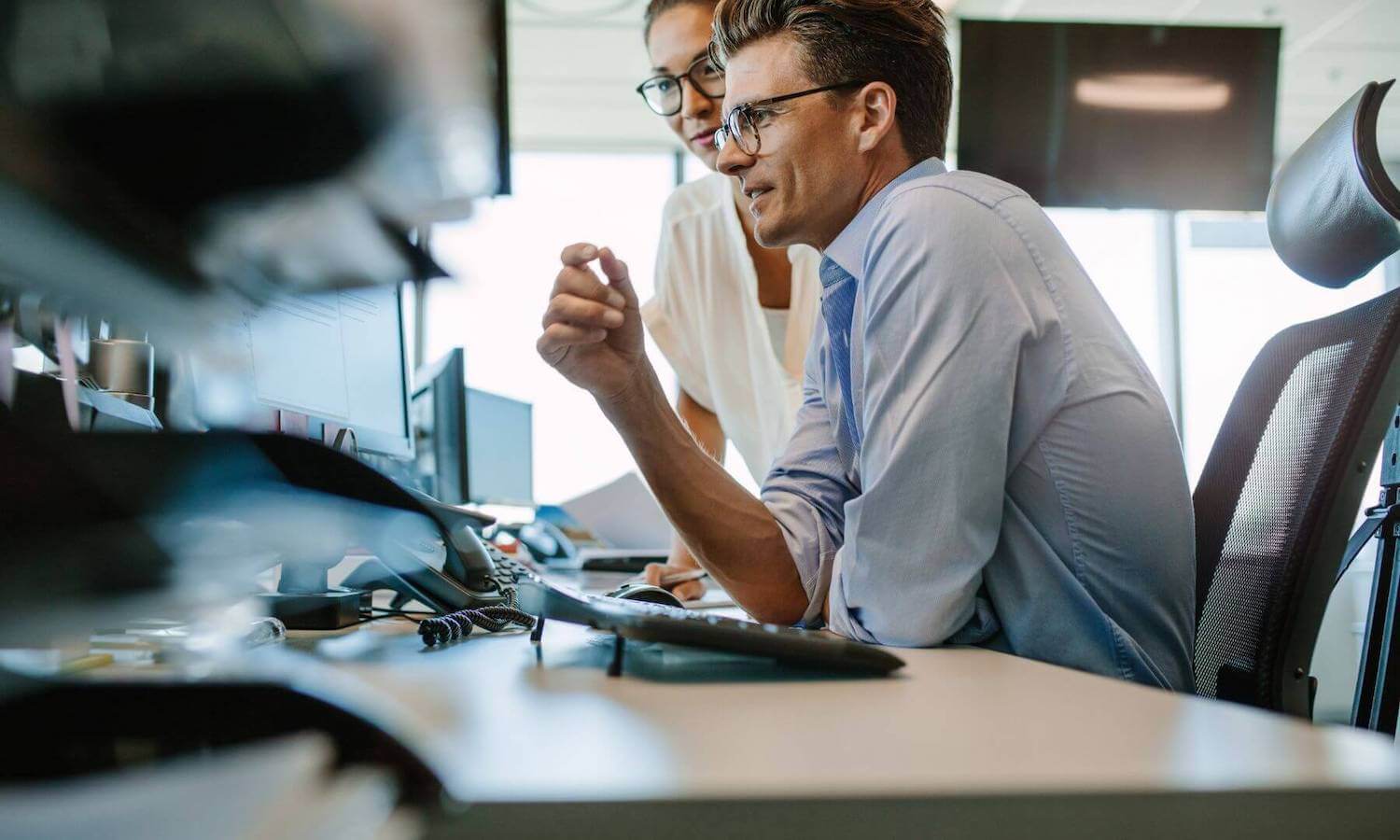 IT staff looking at computer screen assessing email security tool