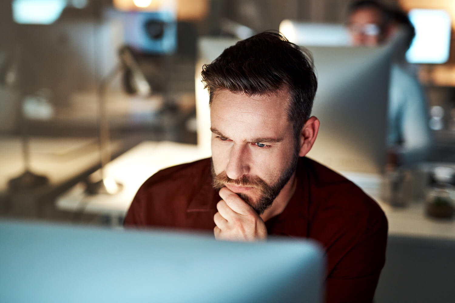 IT team member looking at computer and reviewing email encryption interface