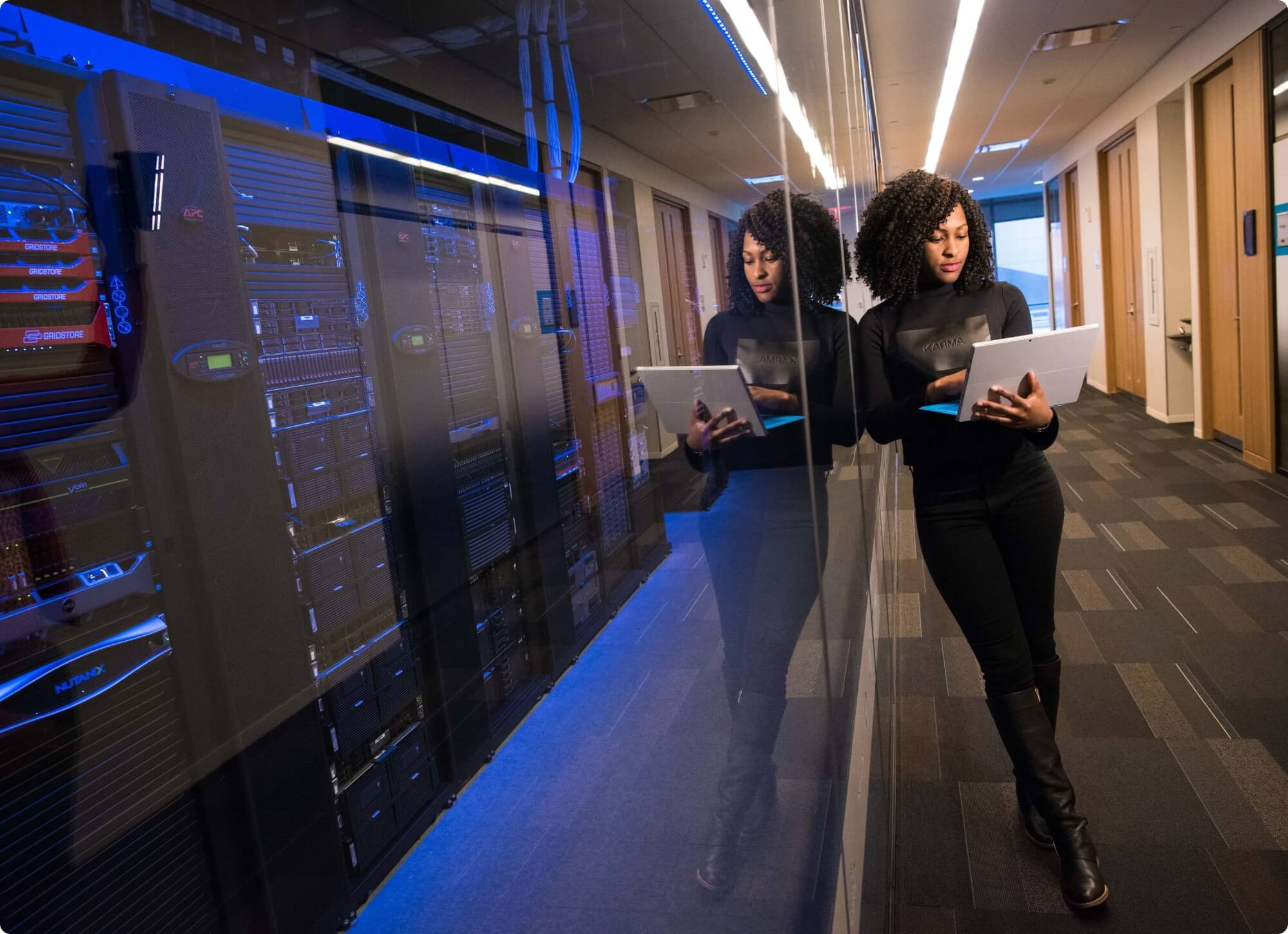 IT expert standing by servers in corporate office configuring email security
