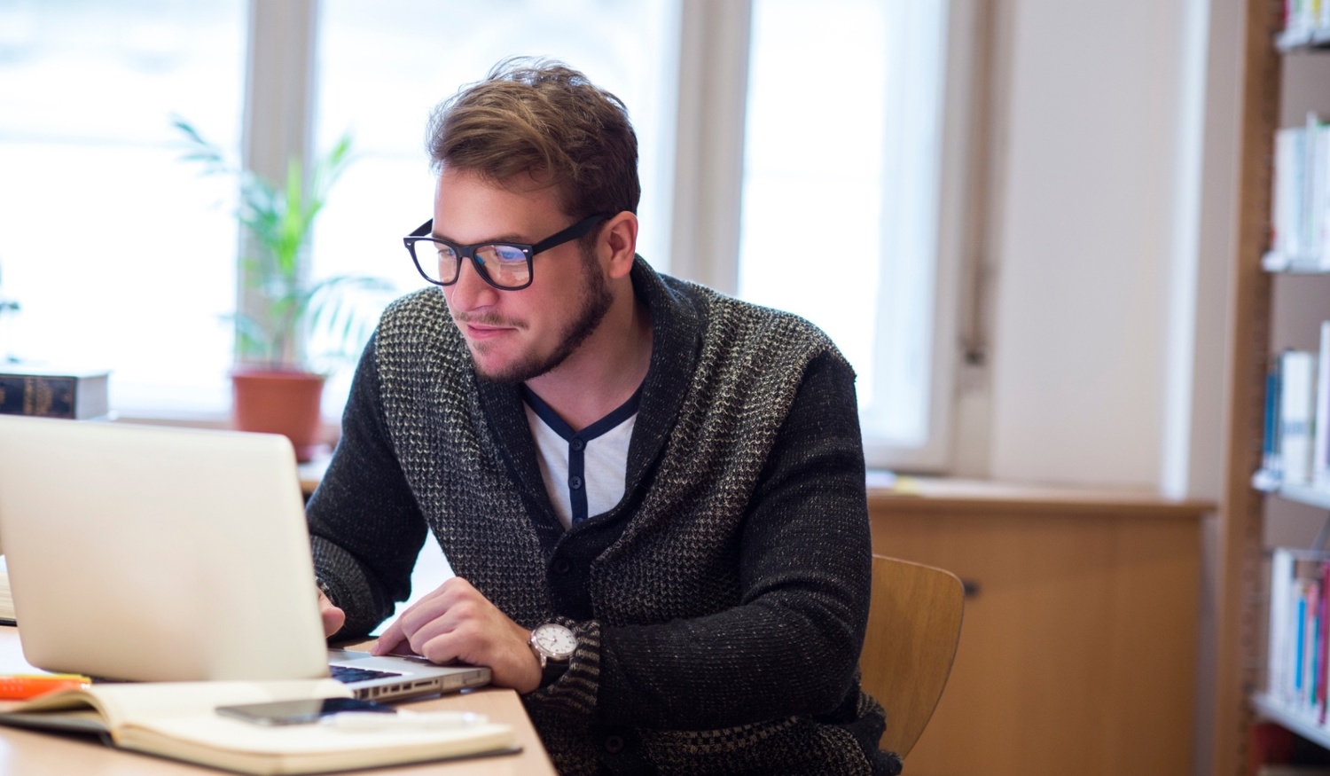 man typing on laptop using secure email-1