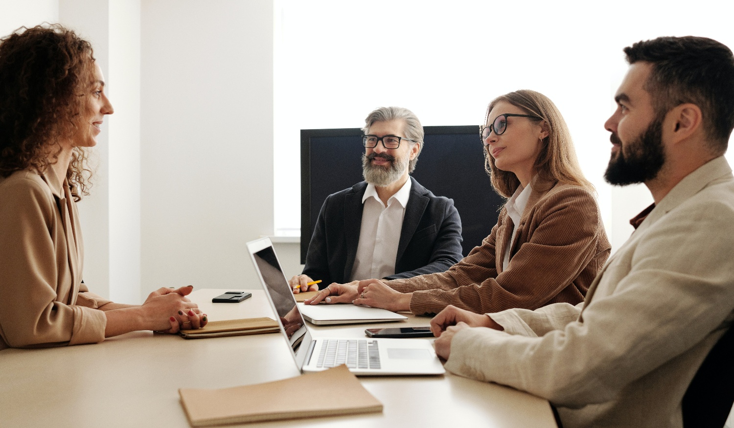 business team sitting around table in office meeting