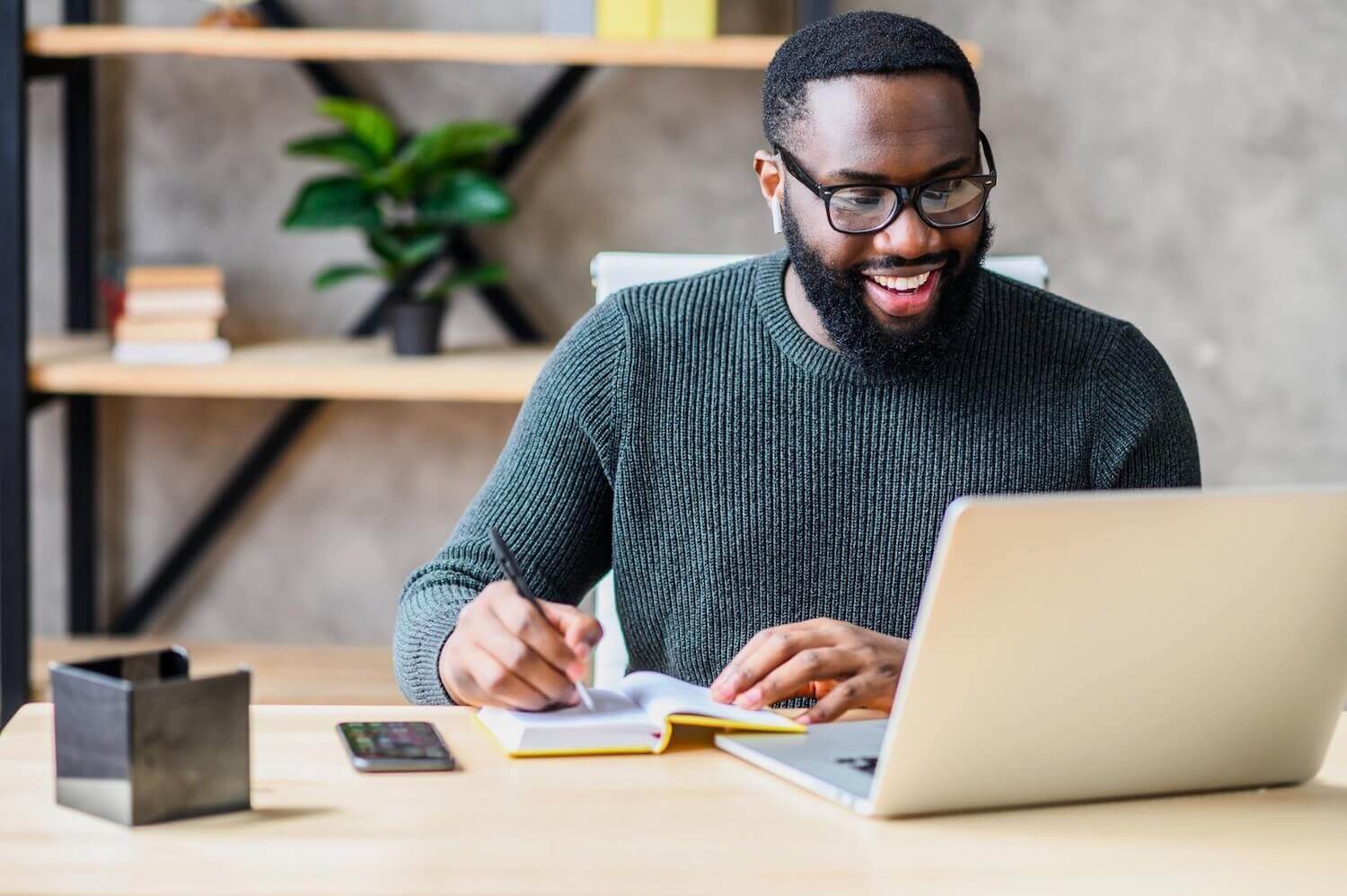 Independent financial adviser looking at laptop with secure email on and smiling