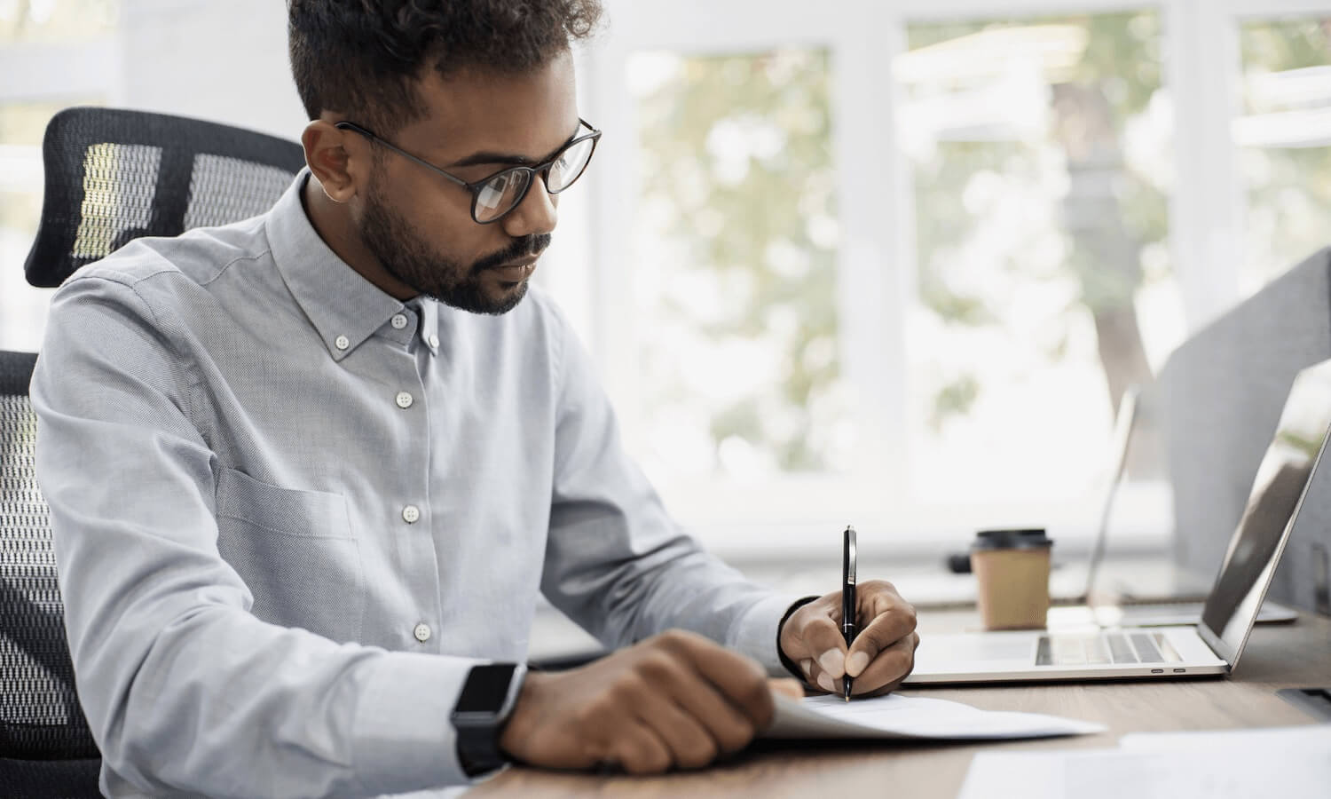 Man writing sensitive information on paper