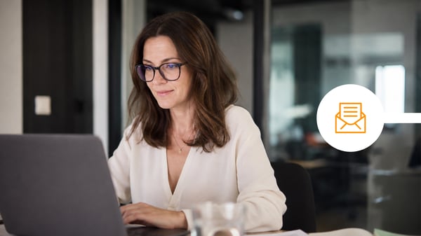 Professional woman typing a secure email on her laptop