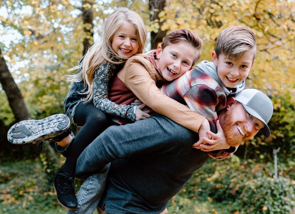 Man and his kids in the forest