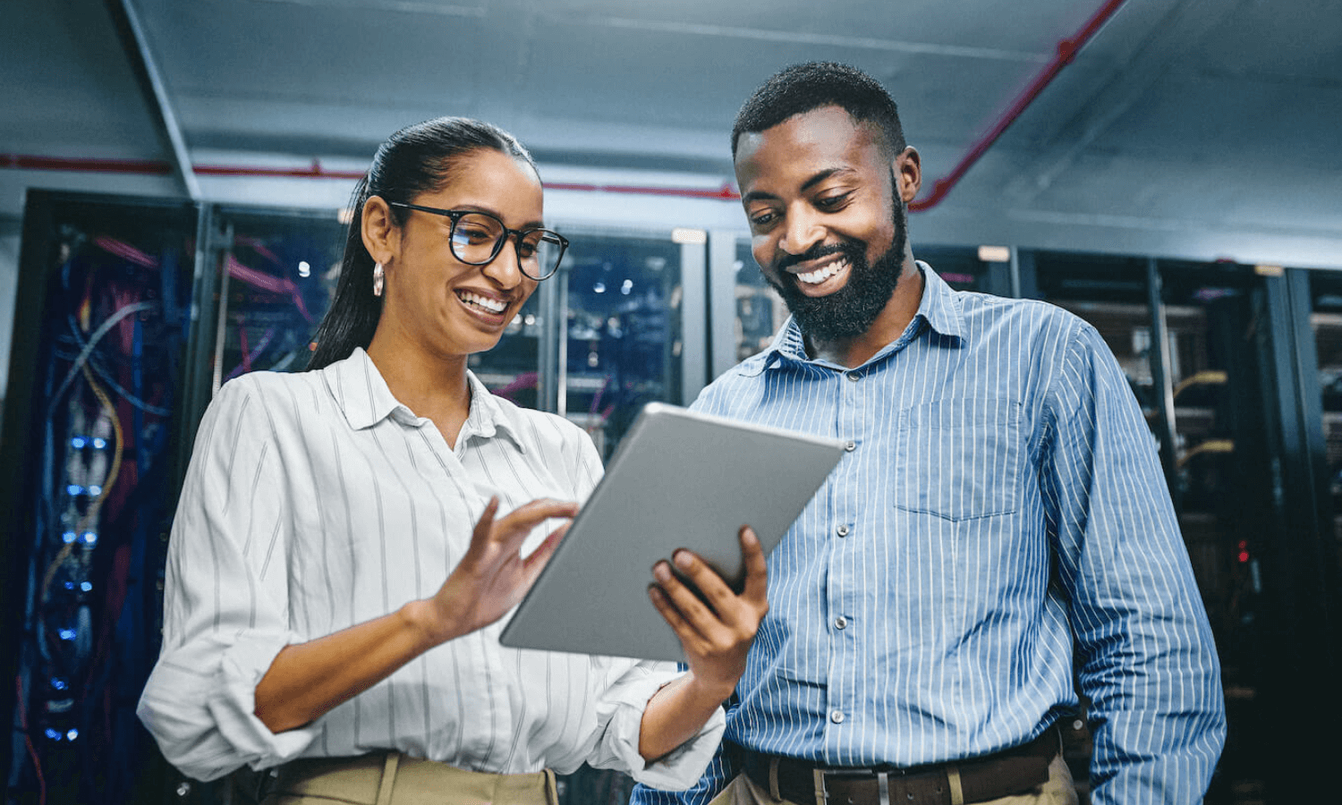 Man and woman in server room deploying email encryption tool