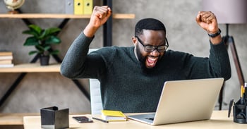 Man at office desk recalling an email in outlook successfully