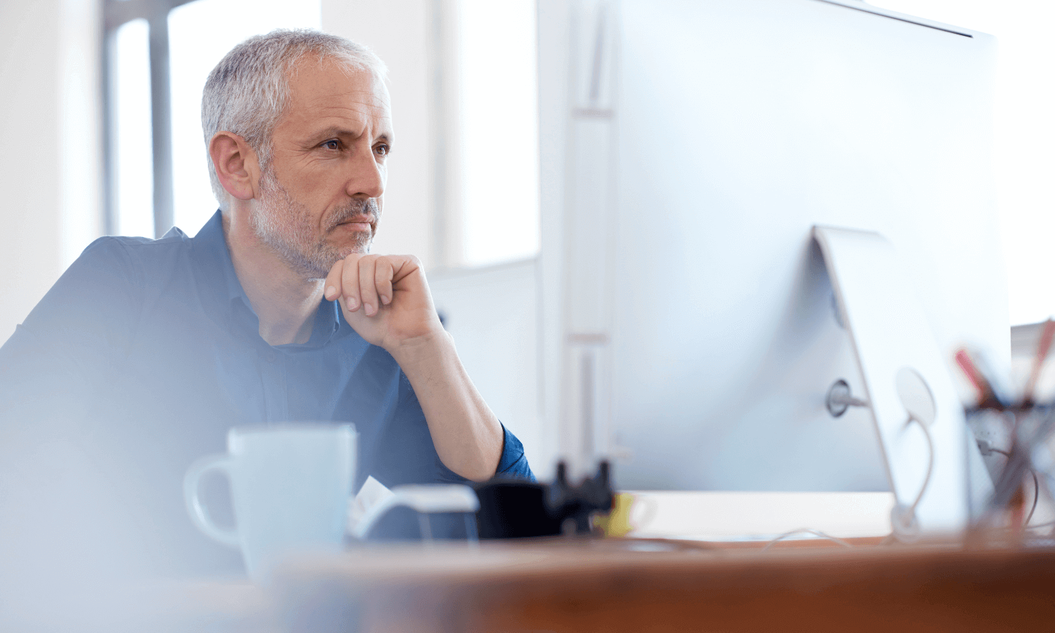Man looking at computer and smiling slightly (1)