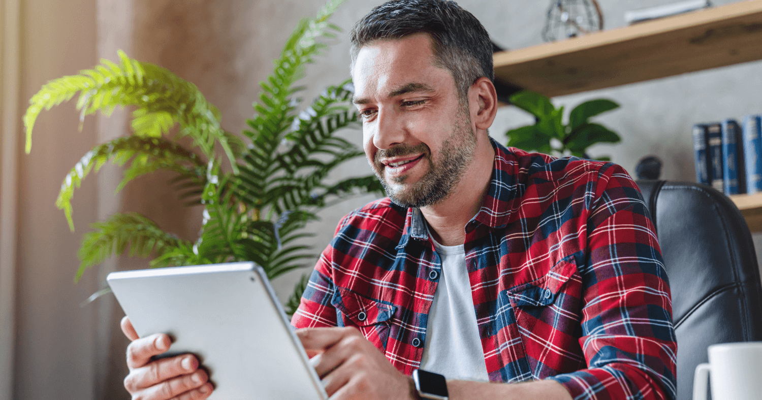 Man looking through outlook add-ins using laptop