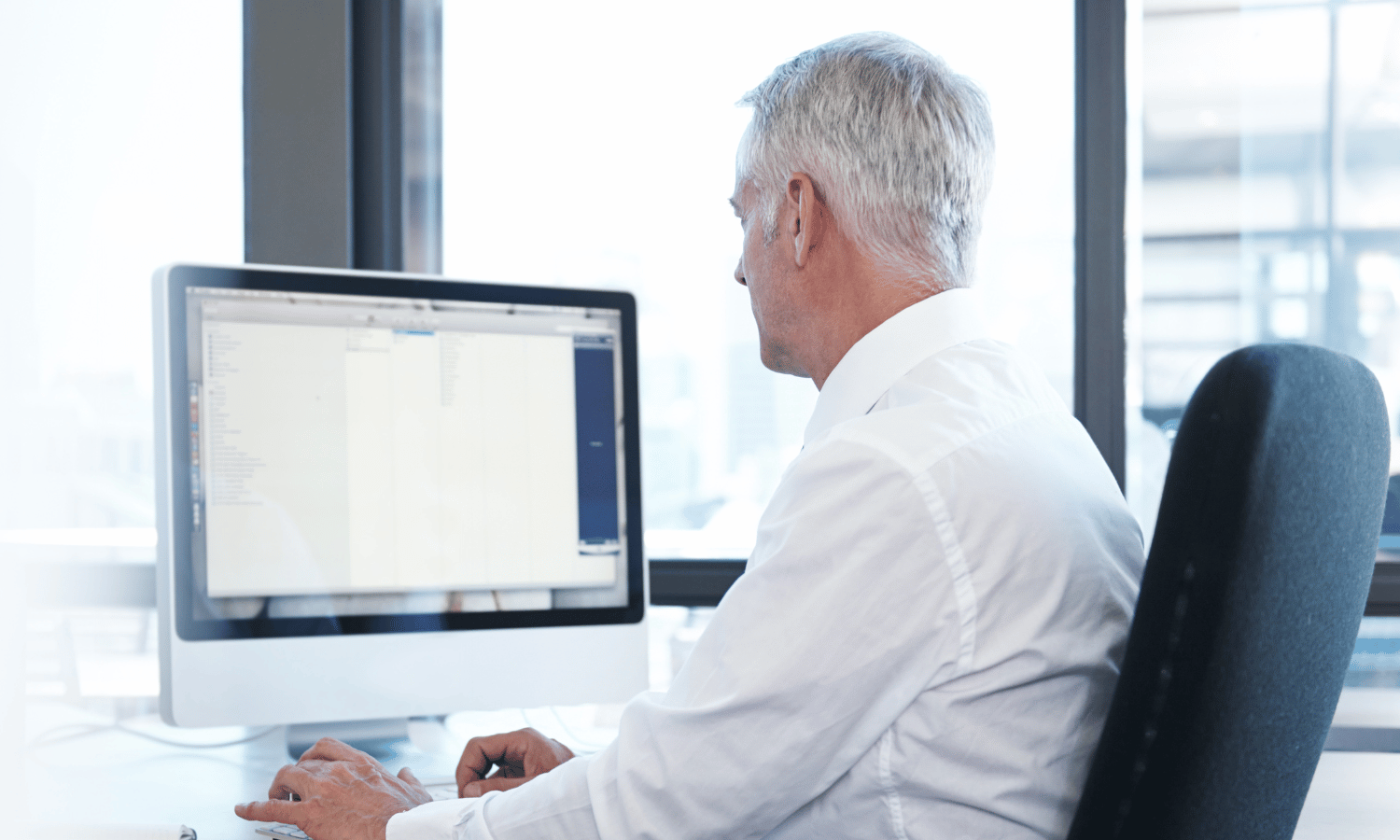 Man using email on his computer in office sending secure email