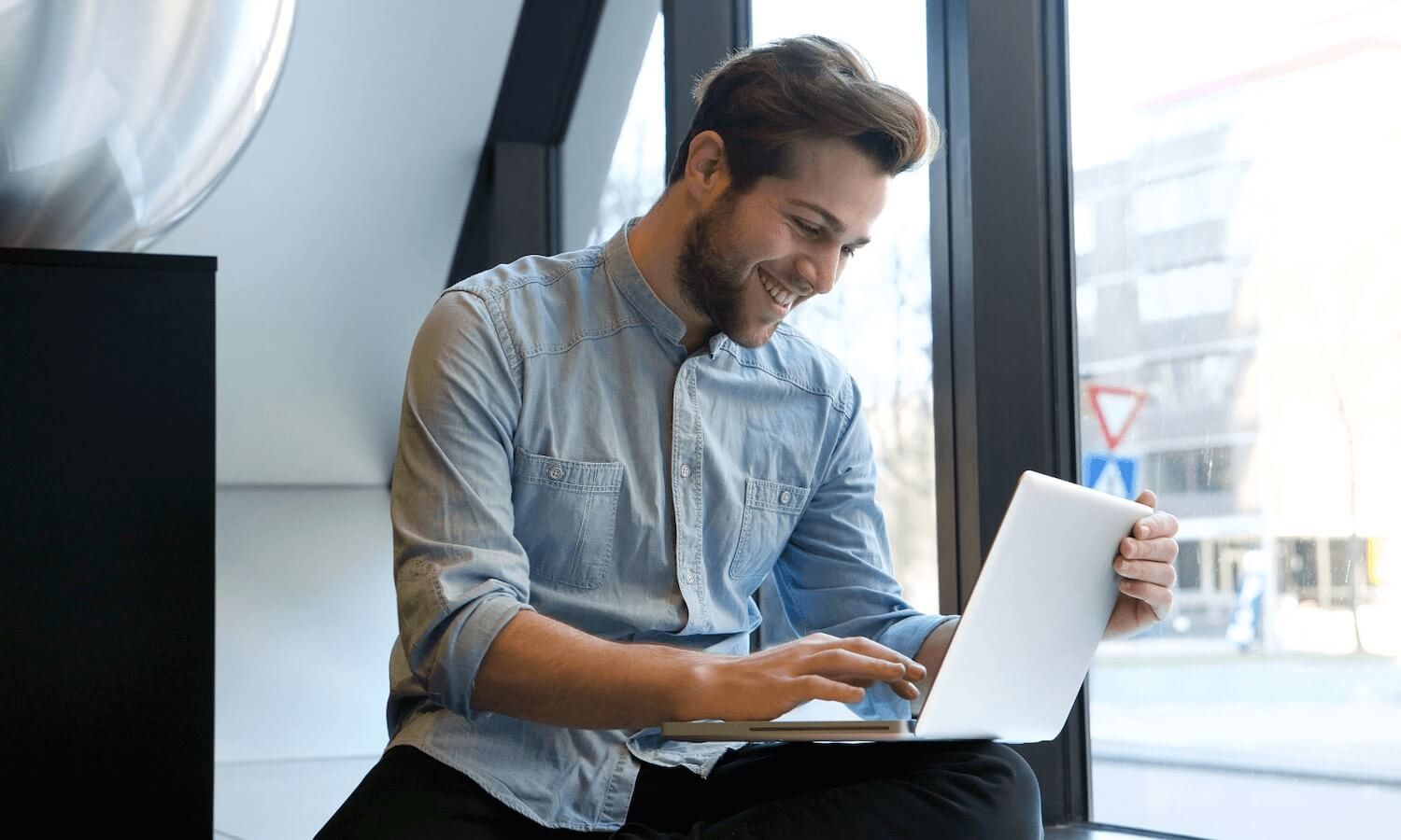 Adviser using laptop to communicate with clients in office