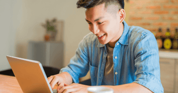 Man using laptop to send emails and install outlook add-ins