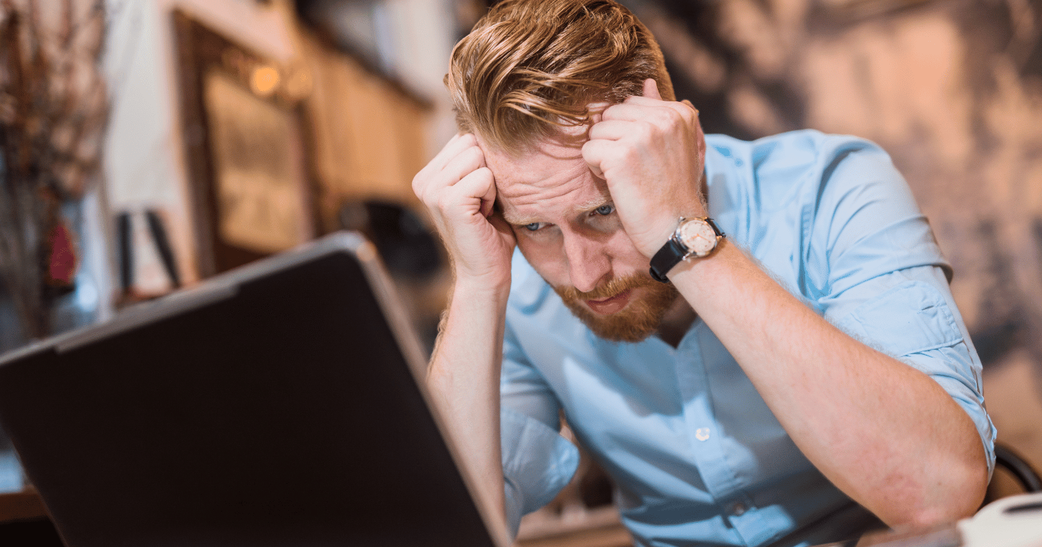 Man with head in hands after sending email unsecured