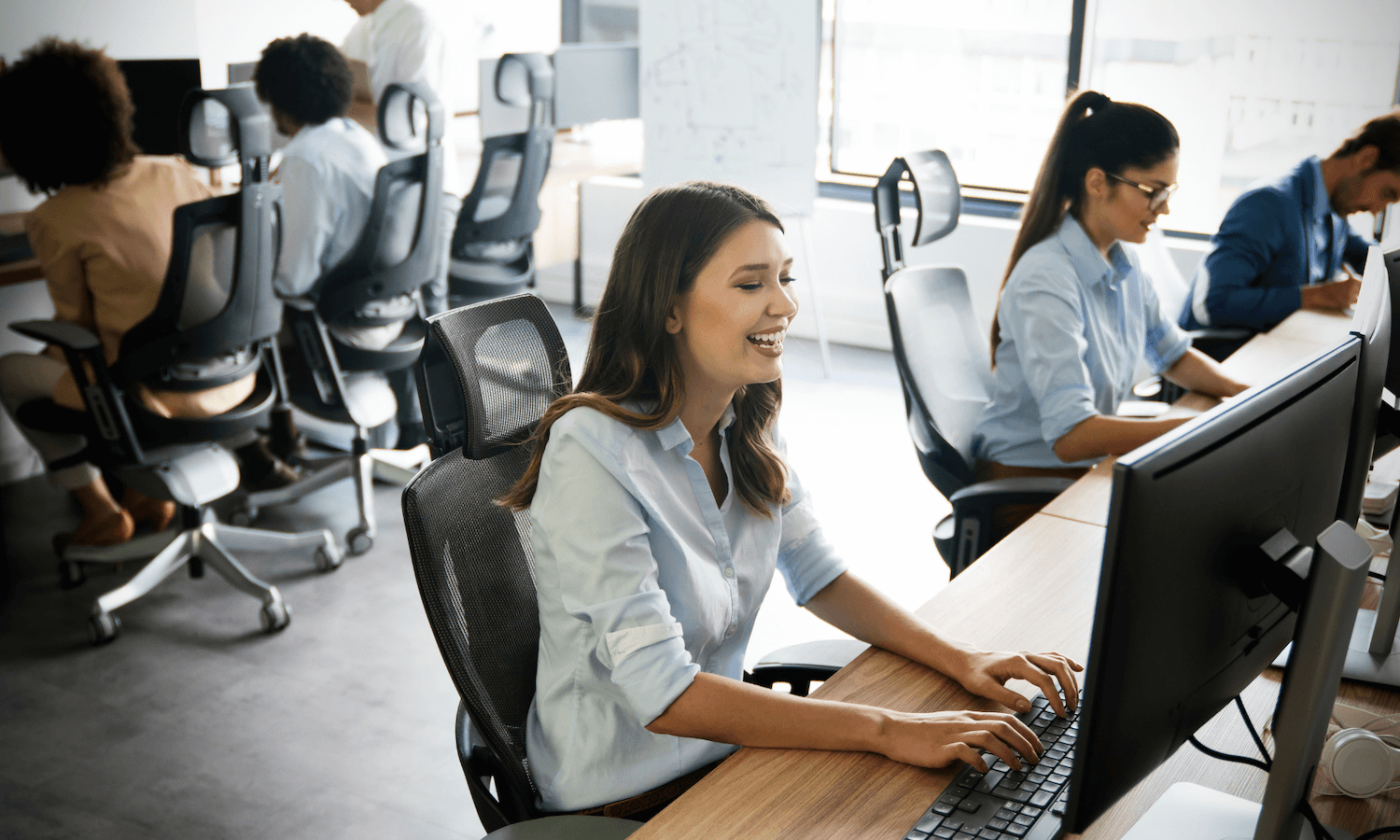 People in office busy working on computers