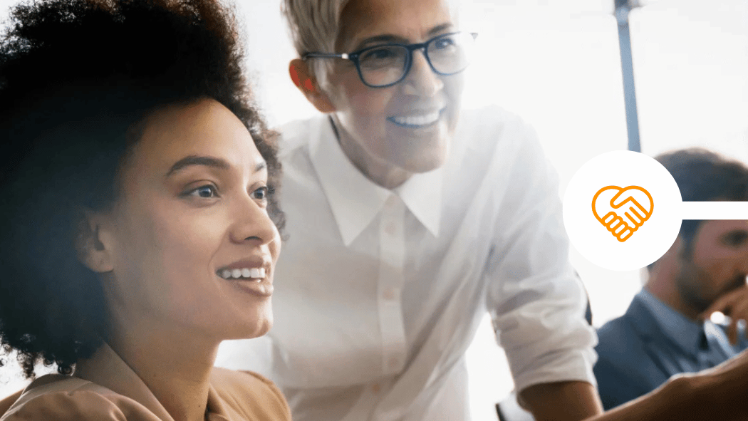 Professional team looking at computer together in office