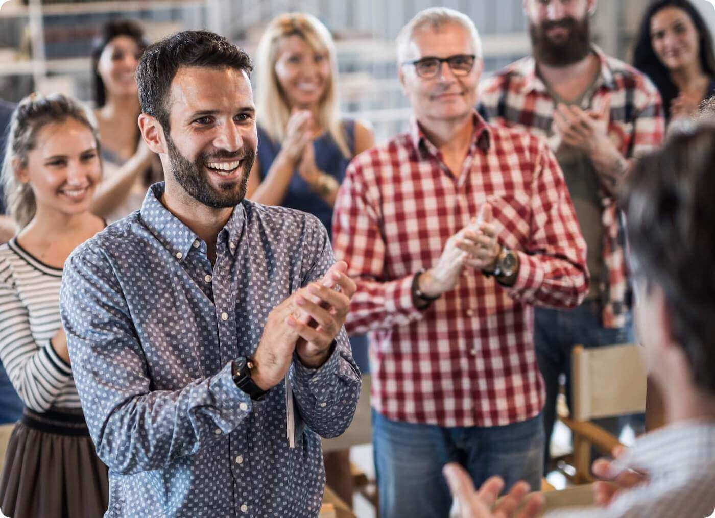 Business team members clapping after a speech