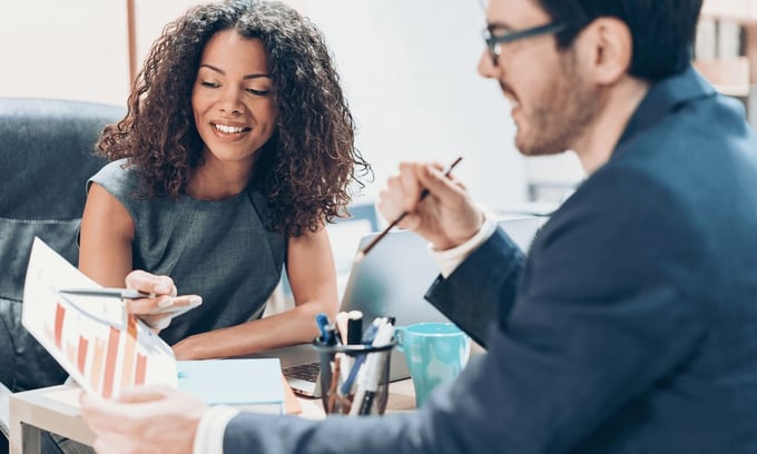 Woman and man in office discussing professional responsibilities and results