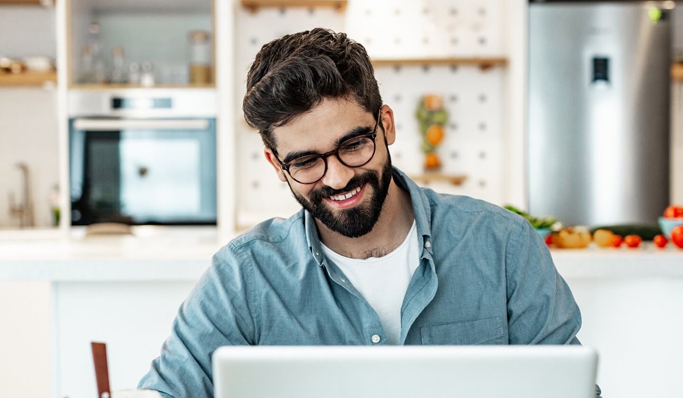 Man discussing mental health with team mate over video call