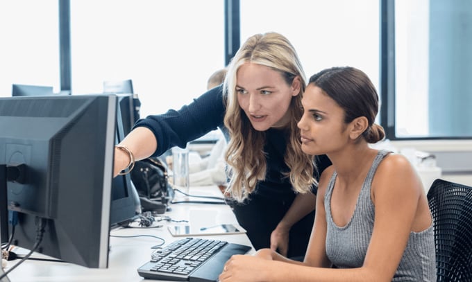 Colleagues in call centre looking at secure email tech
