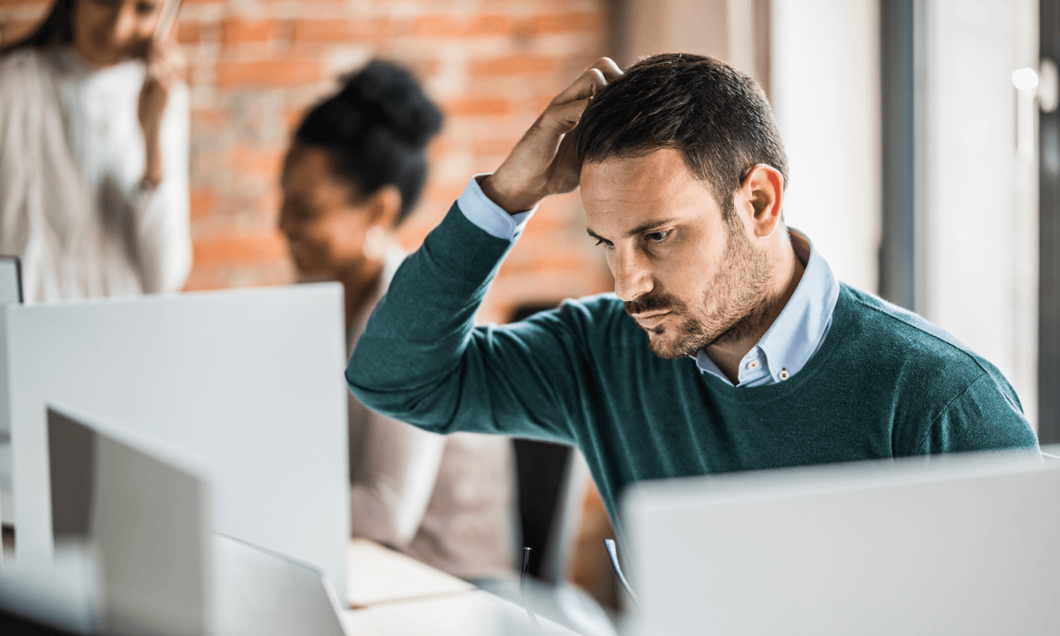 Man scratching his head concerned after sending an email unsecured
