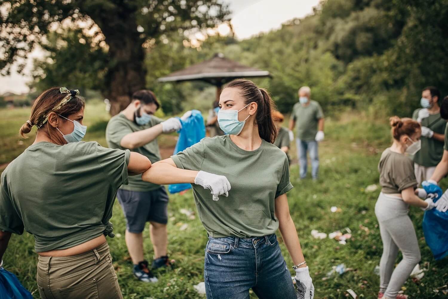 Team doing plastic cleanup and bumping elbows