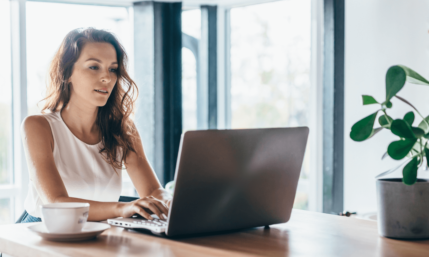 Woman at home using portal on laptop