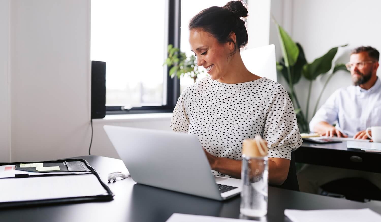 Woman in office securing professional emails on laptop at desk (1)