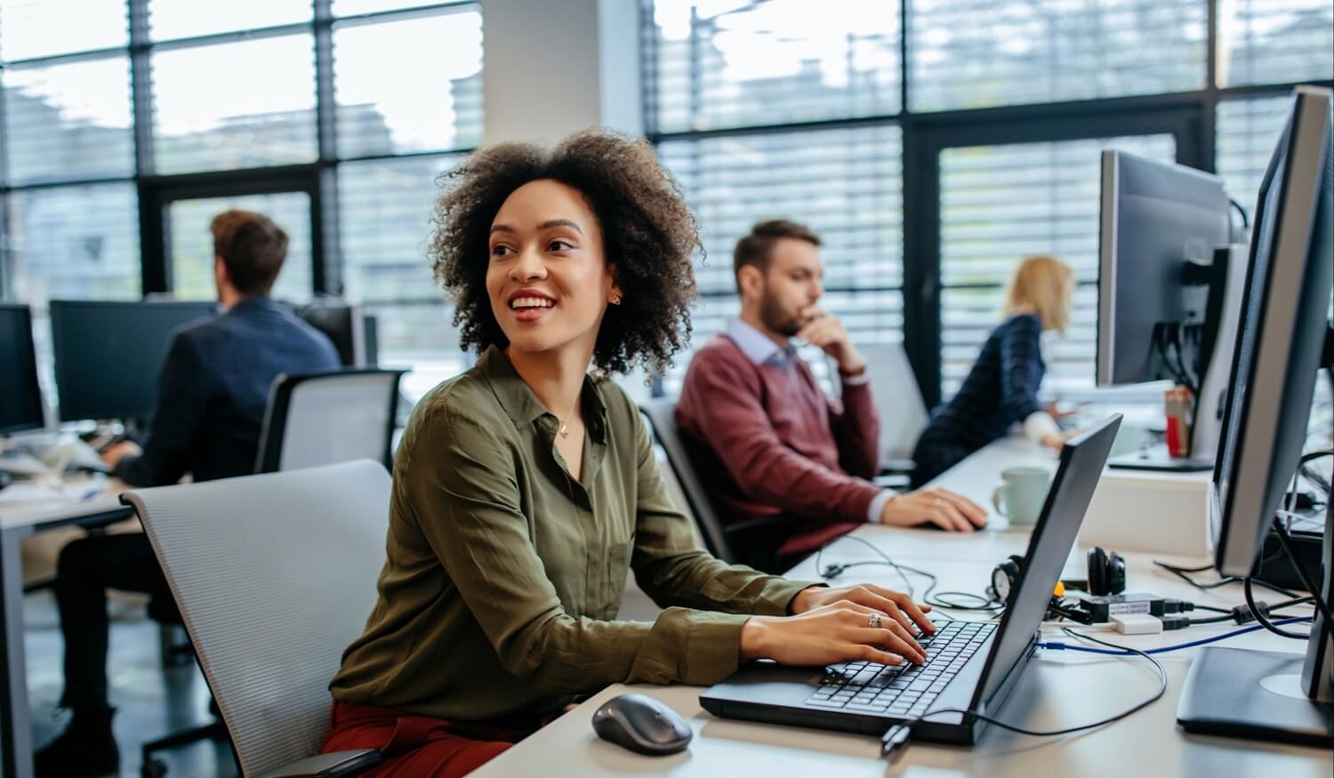 Woman looking around call centre smiling