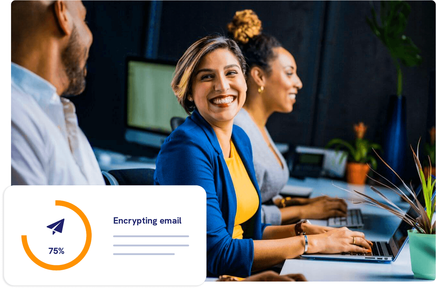 Woman smiling in offer using laptop to secure emails next to colleagues (5)