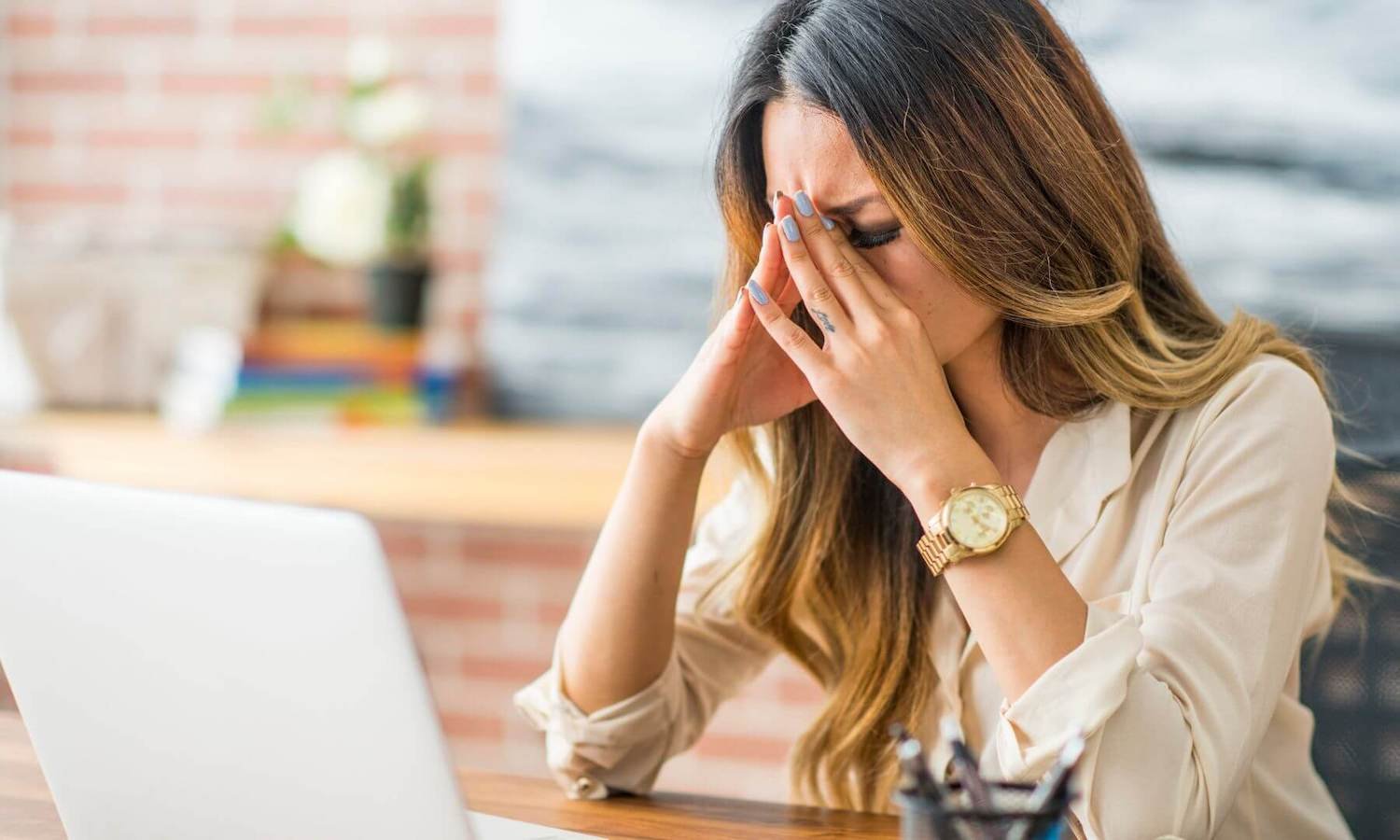 Woman stressed over work pressure at laptop
