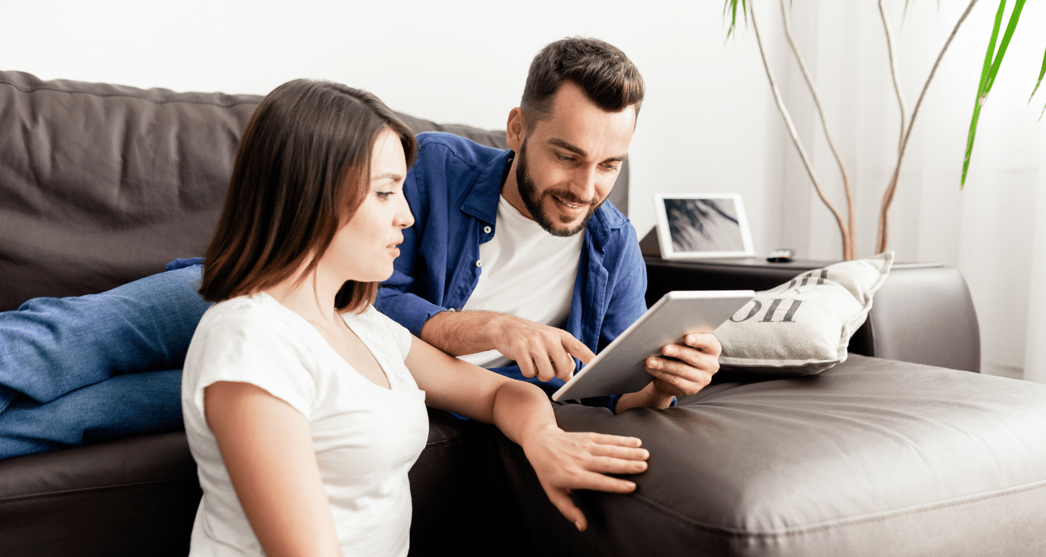 couple at home using tablet