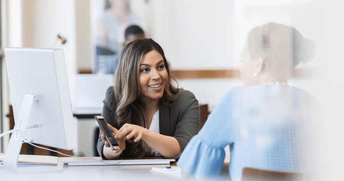 Female office worker helping client with open banking app