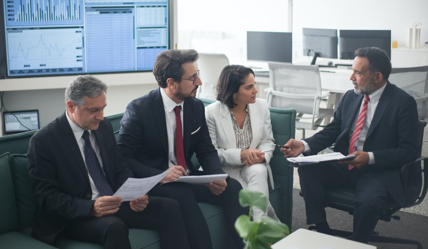 Financial services leaders discussing figures in office