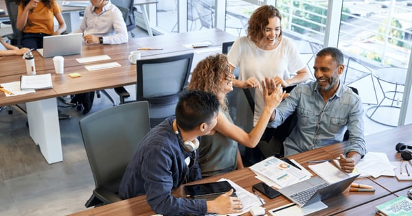 group of colleagues in office high fiving-1