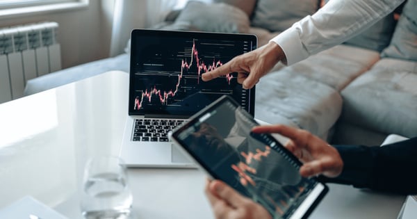 Professionals looking at graph on computer in office