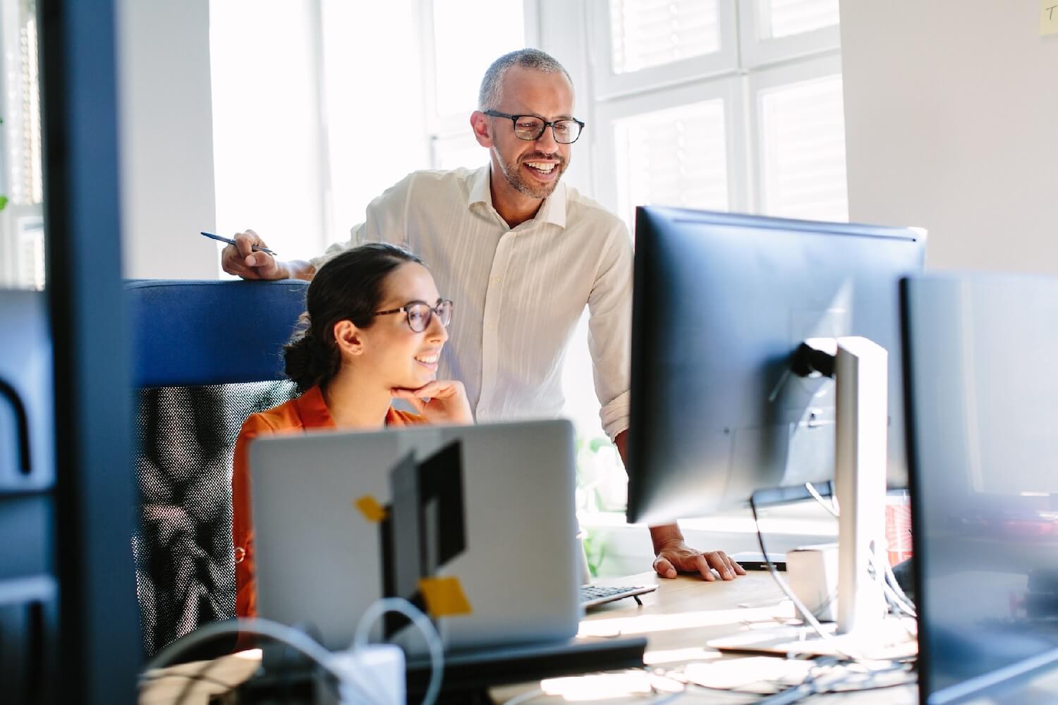 Professional male helping colleague to use secure email system