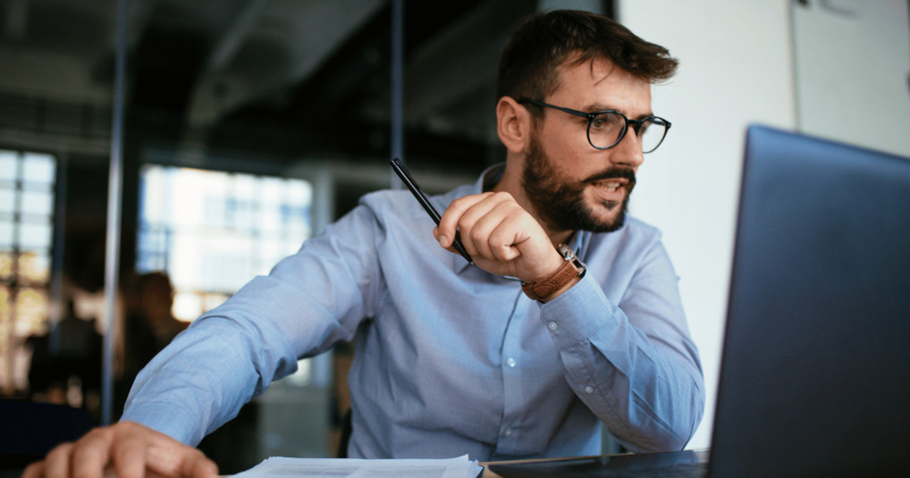 Man looking intently at computer in office