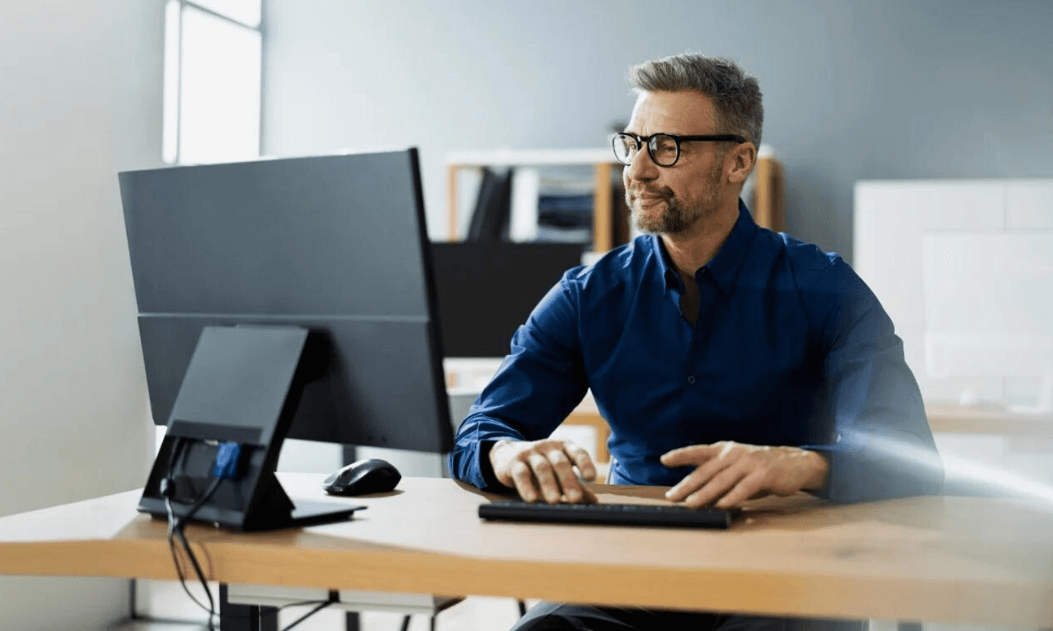 man sending secure email using office desktop computer