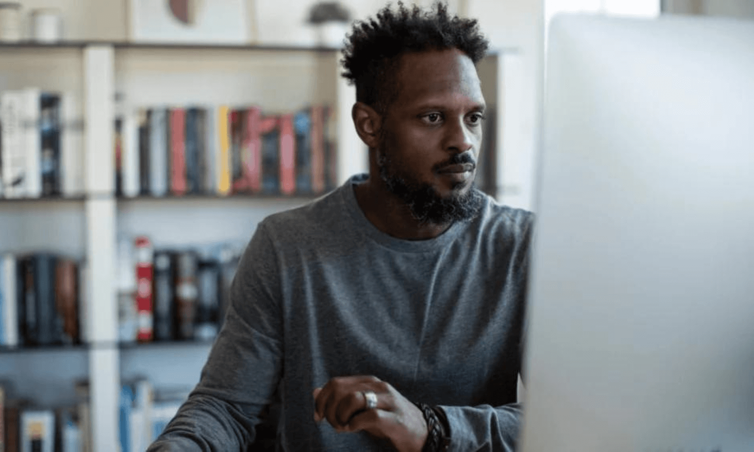 man using desktop computer in home office