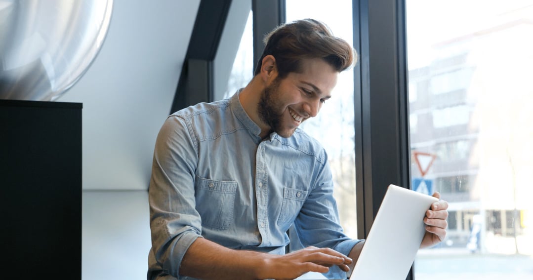 Man using outlook to secure emails and smiling