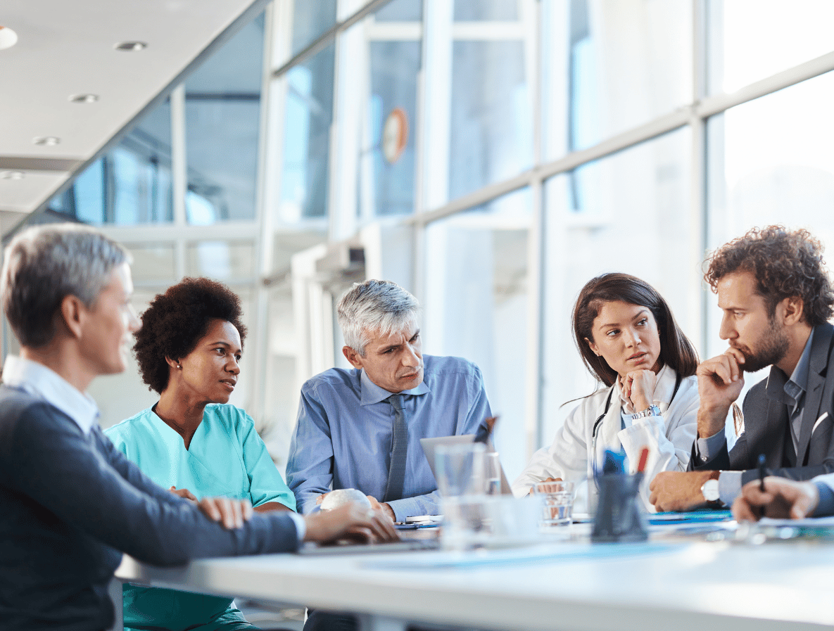 Meeting at board room table in a corporate office