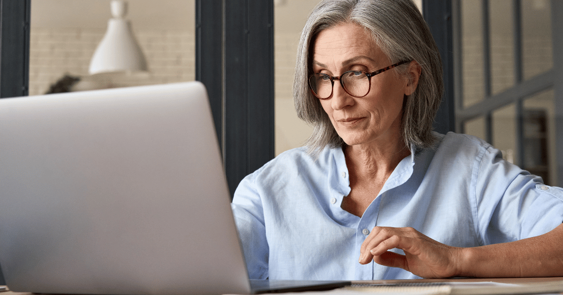 older woman in office receiving email