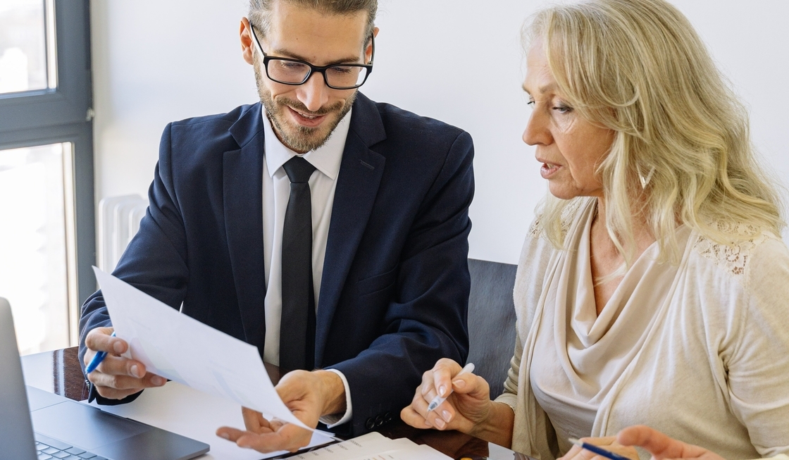 Businessman and woman inspecting a cybersecurity report