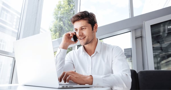 Professional man on phone using laptop