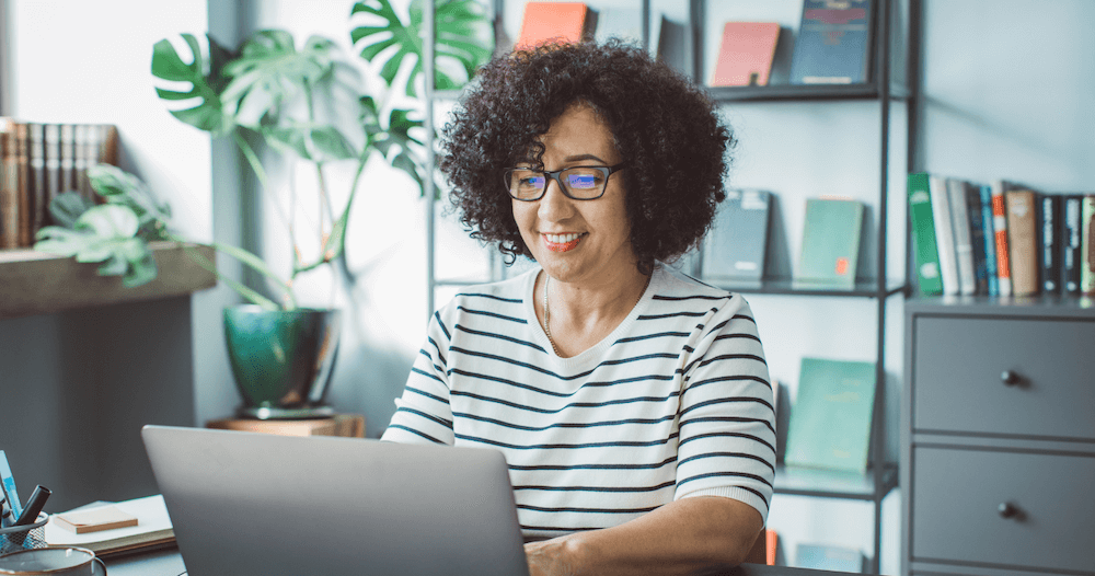 professional woman typing on laptop in office
